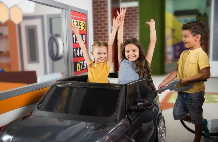 Kids playing gas station in playroom